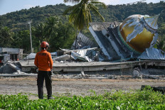 This handout photo taken and released on Monday by the National Search and Rescue Agency (BASARNAS) shows a rescuer conducting operations near a collapsed mosque following a 7.7-magnitude earthquake in Satar Kampas village, East Manggarai, East Nusa Tenggara (NTT). The 7.7-magnitude quake early on Saturday killed 54 people and injured more than 100. Rescue officials have said there were no reports of people missing.
