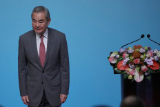 Chinese Foreign Minister Wang Yi reacts during the High-level Meeting on the Global Development Initiative on July 28, 2026 in Beijing.    