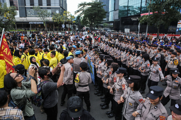 Lines of police officers hold off student protesters from reaching the Hotel Indonesia traffic circle on Jl. Sudirman in Jakarta on Aug. 18, 2026. 