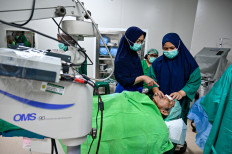 Doctors perform a free cataract eye surgery on a patient under a charity program funded by the Ministry of Health at Meuraxa Hospital in Banda Aceh, Aceh, on June 14, 2026. 
