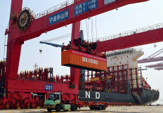 A banner reading &ldquo;Warmly Congratulate the first annual voyage of the China-Europe Arctic Container Route at Ningbo-Zhoushan Port in 2026&ldquo;, is displayed on a container at the Ningbo-Zhoushan port in Ningbo, eastern China's Zhejiang province on Aug. 15, 2026. South Korea will flag off on Saturday a container ship bound for Europe via the Arctic, testing whether ​a route opened by melting sea ice can be commercially viable.