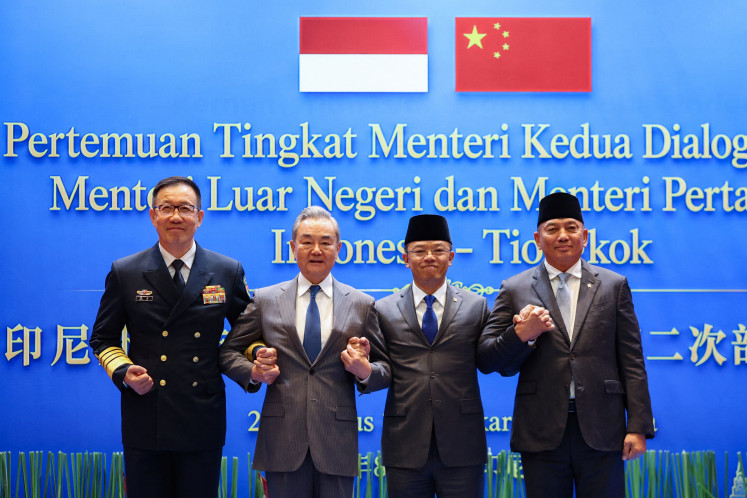 Foreign Minister Sugiono (second right) and Chinese Foreign Minister Wang Yi (second left) stand with their defense counterparts Sjafrie Sjamsoeddin (right) and Dong Jun for a photo op on Aug. 21, 2026, during the Indonesia-China joint foreign and defense ministerial dialogue at the Foreign Ministry in Centra Jakarta.