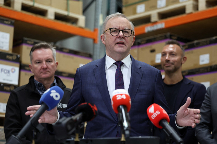 Australian Prime Minister Anthony Albanese (center) speaks during a press conference on the government&rsquo;s home battery installation program with Minister for Climate Change and Energy Chris Bowen (left) and former Olympic swimmer Ian Thorpe (right) in Sydney, Australia, on Aug. 14, 2026.
