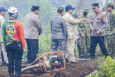 President Prabowo Subianto (center) talks with then-National Police chief Gen. Listyo Sigit Prabowo (second right) and Indonesian Military commander Gen. Agus Subiyanto (right) while inspecting a forest and land fire site in Kubu Raya, Pontianak, West Kalimantan, on Aug. 22, 2026. President Prabowo inspected efforts to tackle forest and land fires in several areas of Kalimantan to ensure the response is swift and effective. 