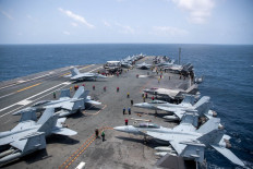 US Navy sailors work on the flight deck of the aircraft carrier USS George Washington as it transits the Arabian Sea to support US military operations in the war with Iran August 20, 2026.
