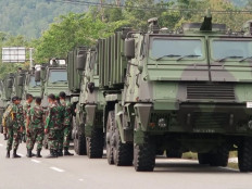 Members of the Indonesian Army gather near a line of Brazilian-made Astros II on Nov. 14, 2019, in Pian Tengah, Natuna, the Riau Islands. The self-propelled multiple rocket launchers comprise the field artillery battery of Composite Battalion 1/Gardapati based in Ranai, Natuna.