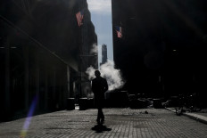 A person walks on Wall Street near the New York Stock Exchange (NYSE) on Feb. 13, 2026  in New York City, the United States.