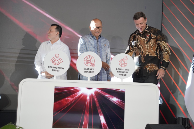 State asset fund Danantara CEO Rosan Roeslani (center) gestures on Monday during the launch of PT Danantara Sumberdaya Indonesia (DSI) alongside DSI CEO Luke Mahony (right) at the Danantara headquarters in Jakarta.