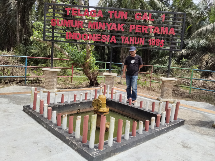 A visitor observes the historic Telaga Tunggal 1 oil well, in operation from 1885 to 2010, on Aug. 11 in Telaga Said village, Langkat regency, North Sumatra. Experts from the North Sumatra Cultural Heritage Team are preparing a proposal to designate Indonesia's first commercial oil well as national cultural heritage.
