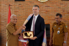 North Sumatra Vice Governor Surya (left) shakes hands with Belgian Ambassador to Indonesia David Jordens (center) next to assistant to North Sumatra Secretary for governance and people's welfare Basarin Yunus Tanjung, during a meeting in Medan on Aug. 24, 2026. Jordens said he planned to reactivate the Belgian honorary consul post in Medan, given the city's strategic position as one of Indonesia's international gateways and its status as the largest city on Sumatra. 