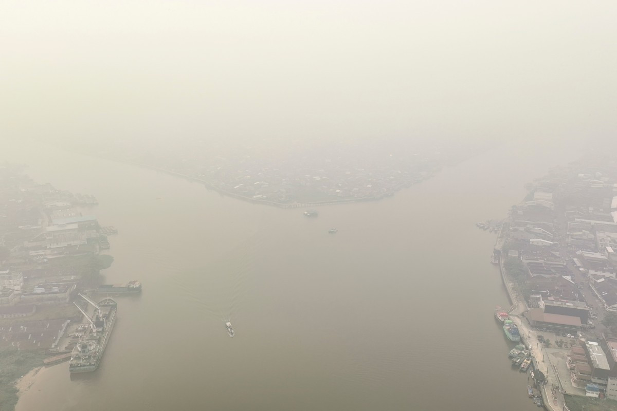 The Kapuas River delta, formed by the Landak (left) and Kapuas Kecil rivers, looms out of thick haze on Aug. 27, 2026, in Pontianak, the provincial capital of West Kalimantan.