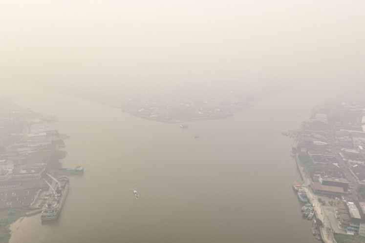 This aerial photo shows smoke from forest and land fires blanketing the city of Pontianak, West Kalimantan on August 27, 2026. 