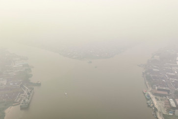 This aerial photo shows smoke from forest and land fires blanketing the city of Pontianak, West Kalimantan on August 27, 2026. 