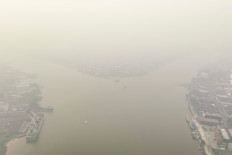 This aerial photo shows smoke from forest and land fires blanketing the city of Pontianak, West Kalimantan on August 27, 2026. 