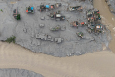 An aerial view shows houses lying deluged in sludge after flash floods at Devighat, Bidur Municipality, along the confluence of the Trishuli and Tadi rivers in Nepal's Nuwakot district on August 27, 2026. Nepal's disaster agency said that 823 people remained out of contact on August 27, more than 24 hours after a deadly flood tore through the border region with Tibet. 