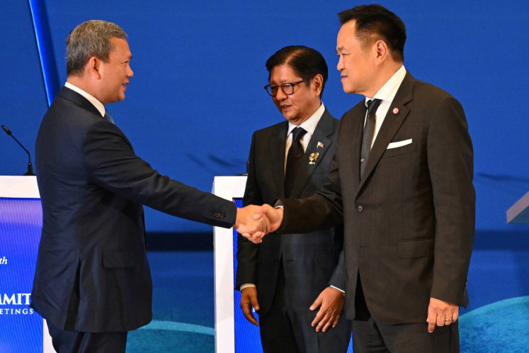 Thai Prime Minister Anutin Charnvirakul (right) greets Cambodian Prime Minister Hun Manet (left) alongside Philippine President Ferdinand Marcos Jr. on May 7, 2026, after their trilateral meeting ahead of the 48th ASEAN summit in Cebu, the Philippines.