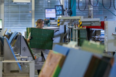 An employee is seen inside the production facilities of high-end printed circuit boards (PCBs) and integrated circuit (IC) substrates manufacturer AT&S  on Aug. 11 in Leoben, Styria, Austria.