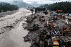 A drone view shows damaged buildings and houses covered in mud next to the Likhu River following deadly flash floods and mudslides, in Devighat, Nuwakot district, Nepal, August 30, 2026.