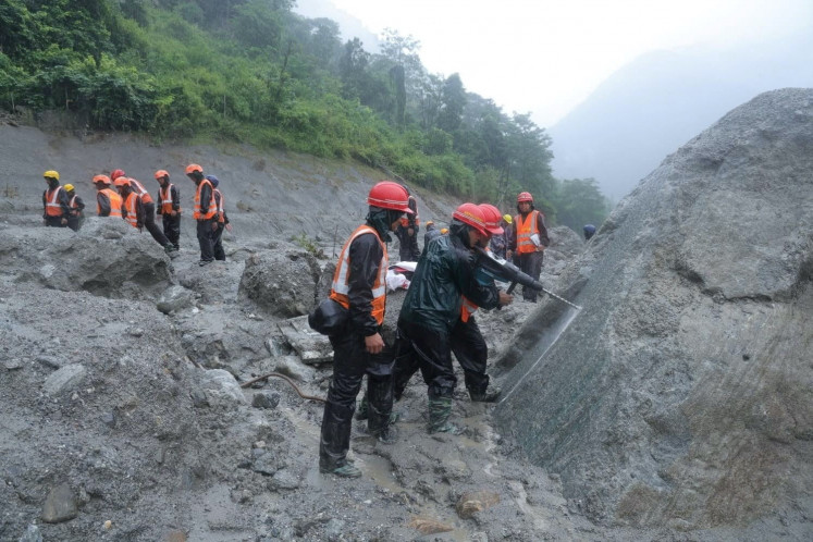 An undated handout photo released Sunday shows rescue workers taking part in a rescue operation near a tunnel at the Trishuli 3A Hydropower Project following deadly flash floods and mudslides in Rasuwa, Nepal.