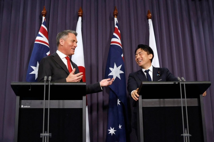 Australian Deputy Prime Minister and Minister for Defence Richard Marles (left) shares a light moment with Japanese Defense Minister Shinjiro Koizumi on Aug. 18, 2026, during a joint news conference at Parliament House in Canberra.