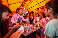 Children at an evacuation shelter in Ruteng, NTT, participate in a coloring activity as part of psychosocial support and trauma-healing efforts following the earthquake. (Courtesy: Dwi Pambudo)