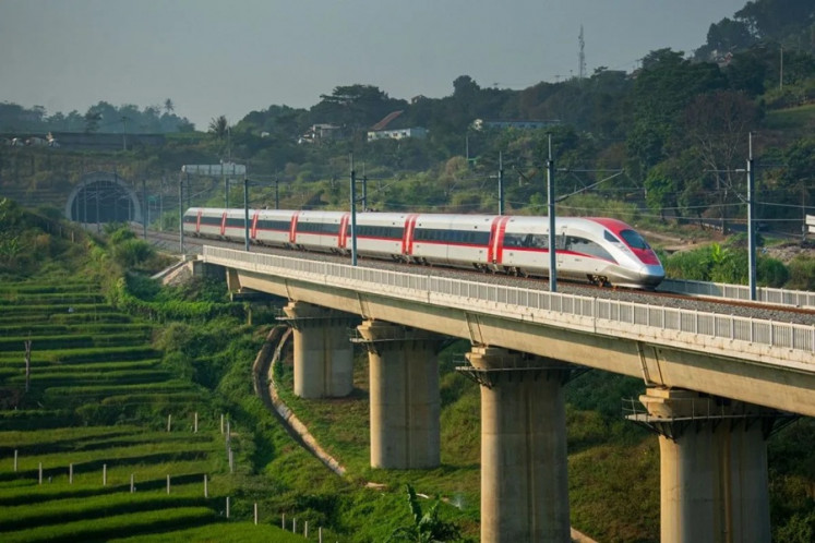 A train of the Jakarta-Bandung High-Speed Rail (HSR) service, which operates under the Whoosh brand, passes an elevated rail over rice fields on Aug. 12, 2026, as it heads toward Padalarang Station in West Bandung regency, West Java.