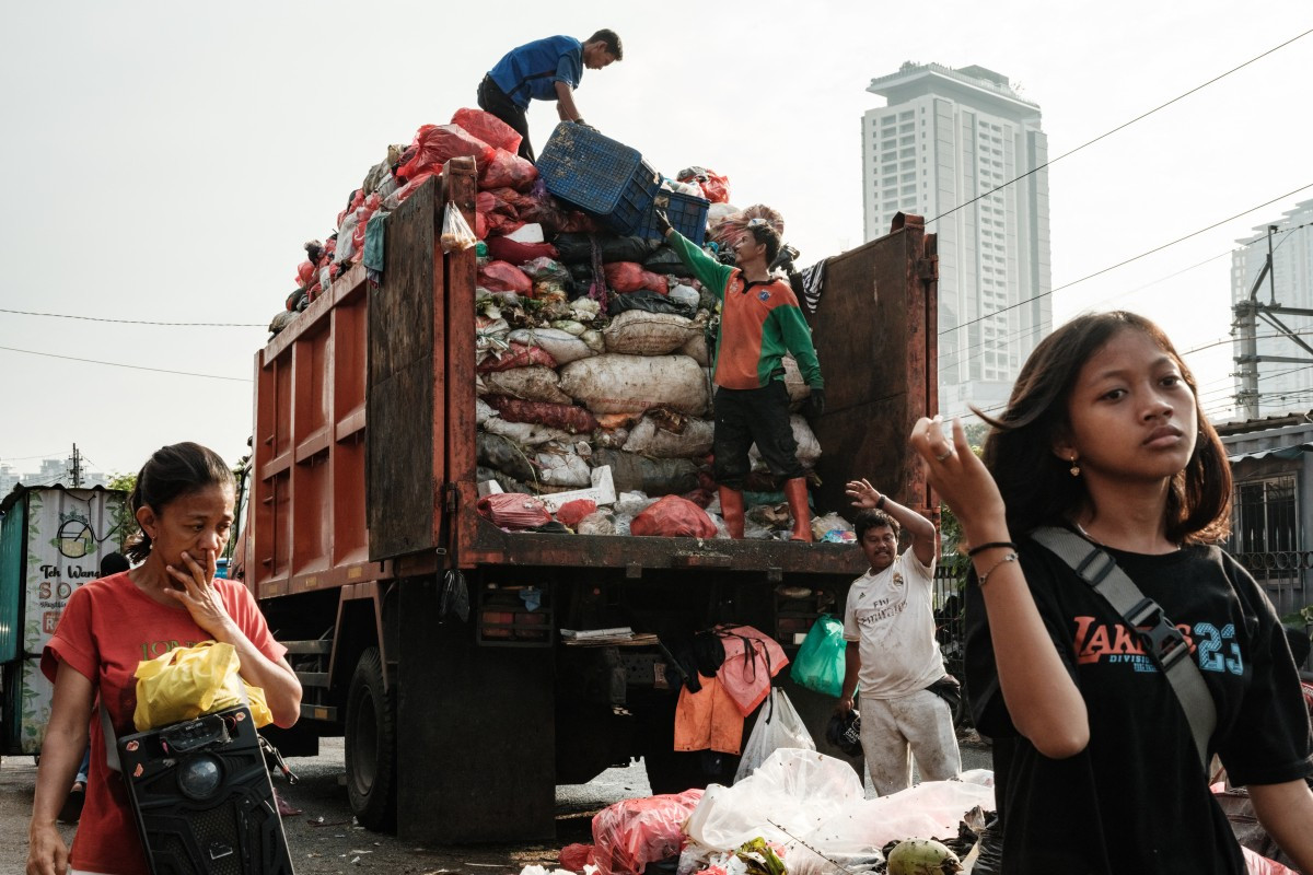 Workers load trash into a truck on April 4 in Jakarta. 