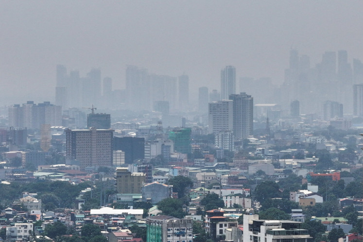 A thick haze shrouds Metro Manila due to smoke from ongoing fires in Kalimantan on Sept. 1, 2026, seen from Quezon City, Philippines.
