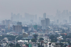 A thick haze shrouds Metro Manila due to smoke from ongoing fires in Kalimantan on Sept. 1, 2026, seen from Quezon City, Philippines.