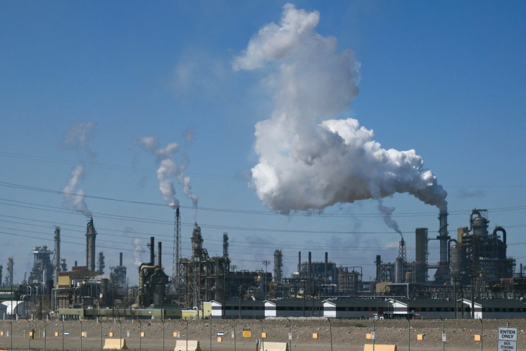 Smoke drifts from an oil refinery on May 5, 2026, from a Syncrude joint venture site in Alberta's Wood Buffalo, Canada.