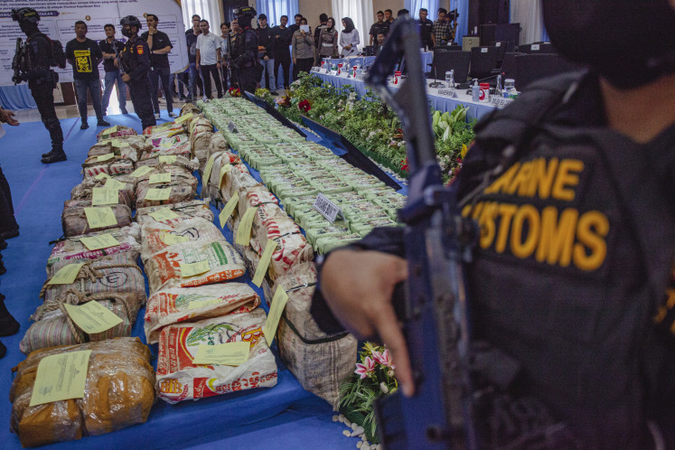 Armed officers stand guard near a pile of evidence during a news conference on a drug smuggling case at the Riau Islands Police headquarters in Batam, Riau Islands, on Sept. 1, 2026. A joint team from the National Narcotics Agency (BNN), the National Police Criminal Investigation Department (Bareskrim Polri), the Directorate General of Customs and Excise and the Riau Islands Police intercepted 800 kilograms of ketamine in Riau Islands waters, and named a Taiwanese national, identified by the initials BNC, as a suspect accused of acting as the syndicate's controller.