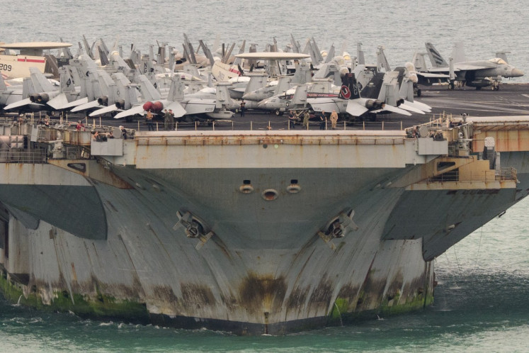 Aircrafts are seen on the flight deck of US nuclear-powered aircraft carrier USS Abraham Lincoln (CVN-72) as it heads towards Laem Chabang Port, near the city of Pattaya on September 2, 2026. 