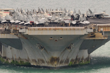 Aircrafts are seen on the flight deck of US nuclear-powered aircraft carrier USS Abraham Lincoln (CVN-72) as it heads towards Laem Chabang Port, near the city of Pattaya on September 2, 2026. 