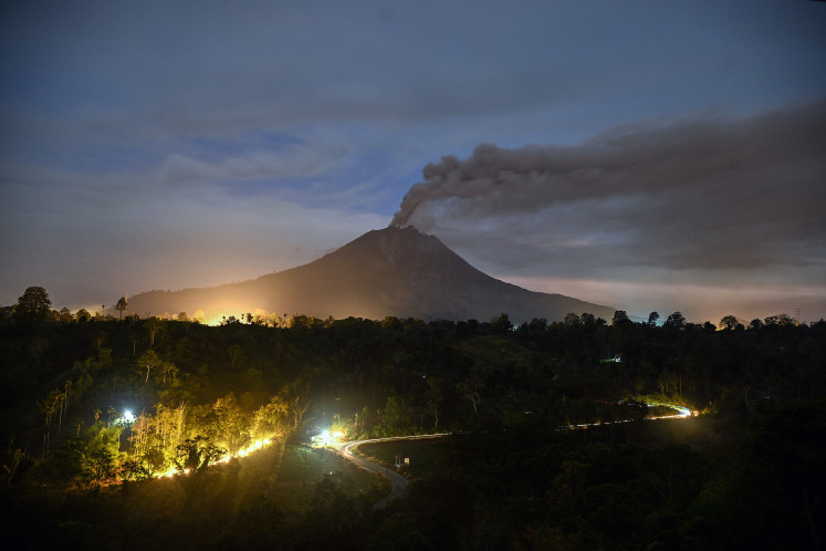 Mount Sinabung spews ash and thick smoke early on Wednesday as seen from Karo, North Sumatra province. 