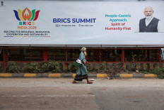 A man walks past a board featuring Indian Prime Minister Narendra Modi on Sept. 3, 2026, ahead of the upcoming BRICS Summit in New Delhi.