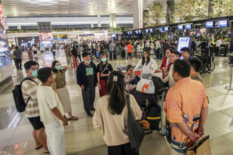 Stranded passengers gather as they wait at Soekarno-Hatta Airport in Tangerang on September 6, 2026. 