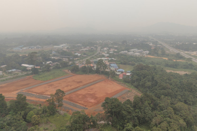 An aerial view shows thick haze over Serian, a town in the Kuching Division of Sarawak, on the island of Borneo on September 5, 2026. 
