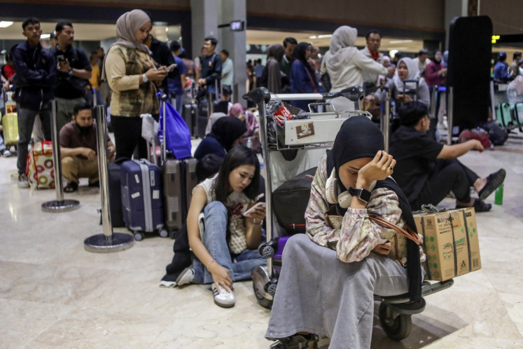 Stranded passengers wait to request refunds after scheduled flights were canceled following the eruption of Mount Anak Krakatau at Soekarno-Hatta airport in Tangerang on September 6, 2026. T
