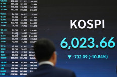 A man looks at an electronic display in Seoul on July 28, 2026, showing the Korea Composite Stock Price Index (KOSPI) after the close of trading.