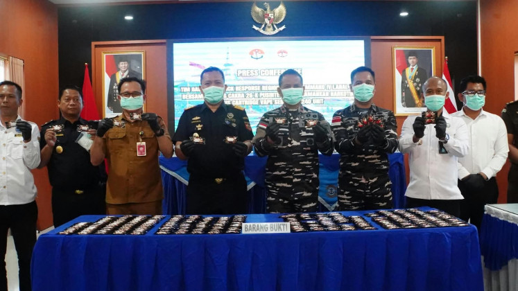 Naval Regional Command (Kodaeral) IV/Batam deputy commander Cdre. Ketut Budiantara (fourth right), flanked by representatives from the Regional Administration Leadership Forum (Forkopimda),  displays siezed etomidate vape cartridges during a press conference at the Tanjung Balai Karimun Naval Base in Tanjung Balai Karimun, Riau Islands, on Sept. 7, 2026. 