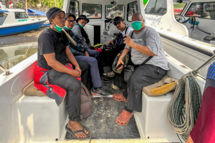 Five journalists pose on a boat on Sept. 7 that took them to cover the eruption of Mount Anak Krakatau in Lampung, before they were reported missing. Rescuers resumed the search operation on Sept. 9 for a speedboat carrying eight people, including the five journalists, that lost contact with the boat owner soon after departure, according to the National Search and Rescue Agency (Basarnas). 