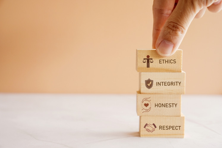 An illustration of wooden blocks showing ethics, integrity, honesty and respect