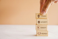 An illustration of wooden blocks showing ethics, integrity, honesty and respect