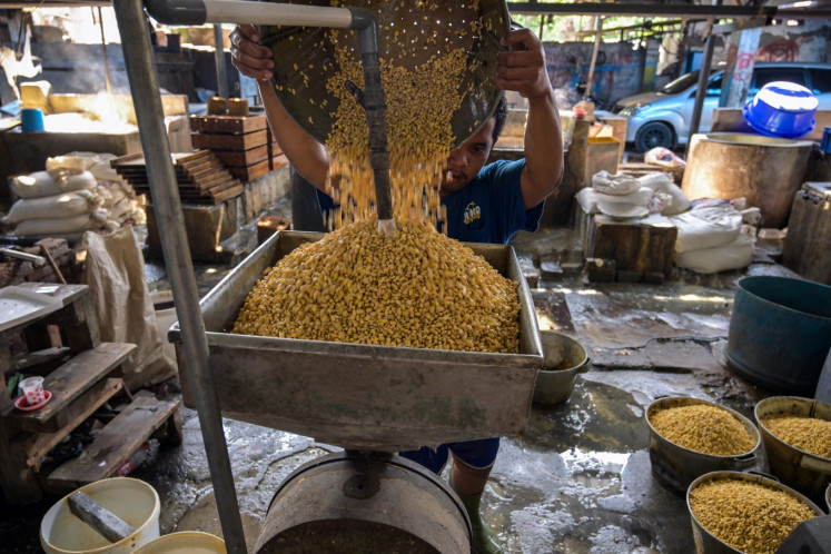 A worker rinses soybeans on Feb. 5, 2026, at a tofu factory in Surabaya, East Java.