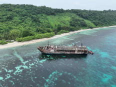 This handout photo taken on Sept. 11, 2026 and released by the Philippine coast Guard (PCG), shows an aerial shot of the ill-fated M/V June Aster with coast guard boats (right) at the stern off the shores of Coron town, Palawan province, the Philippines. The deadly blaze that swept through a Philippine ferry happened &ldquo;in seconds&ldquo;, the coast guard said on Sept. 11, as rescuers battled heavy smoke in the search for dozens of missing people.