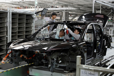 Employees work on the production line at a factory of Chinese electric vehicle (EV) maker Nio in Hefei, Anhui province, China, on April 2, 2025.