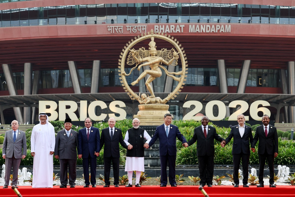 In this pool photograph distributed by the Russian state agency Sputnik, (left to right) Brazil's Foreign Minister Mauro Vieira, UAE's Supreme Council for National Security Secretary-General Ali Mohamed Hammad Al Shamsi, Indonesia's President Prabowo Subianto, Egypt's President Abdel Fattah al-Sisi, Russia's President Vladimir Putin, India's Prime Minister Narendra Modi, China's President Xi Jinping, South Africa's President Cyril Ramaphosa, Iran's President Masoud Pezeshkian and Ethiopia's Prime Minister Abiy Ahmed pose for a family photo during the 18th BRICS Summit in New Delhi. 