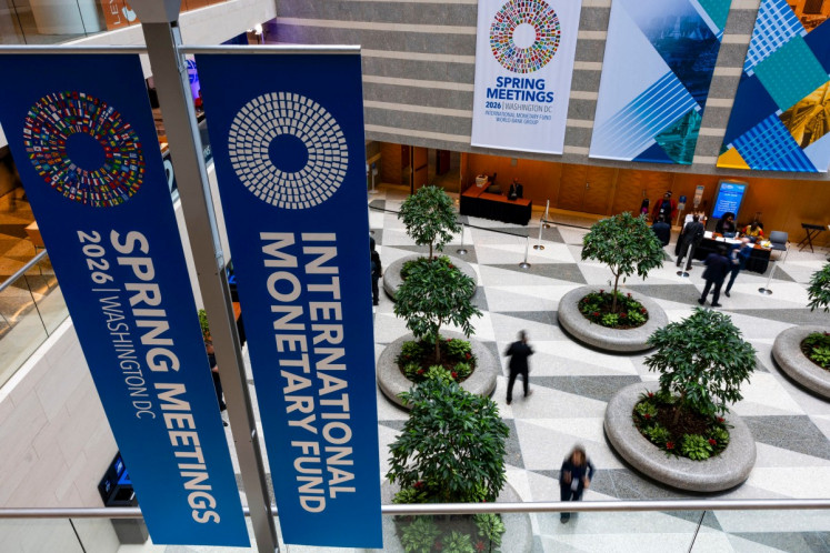 Banners decorate the International Monetary Fund (IMF) headquarters in Washington on April 13, the first day of the 2026 Spring Meetings of the IMF and the World Bank Group (WBG).