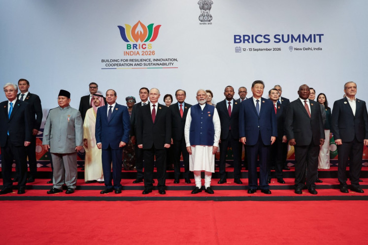In this pool photograph distributed by the Russian state agency Sputnik, leaders of participating countries gather for a family photograph during the 18th BRICS Summit in New Delhi on September 13, 2026. 