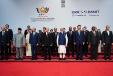 In this pool photograph distributed by the Russian state agency Sputnik, leaders of participating countries gather for a family photograph during the 18th BRICS Summit in New Delhi on September 13, 2026. 